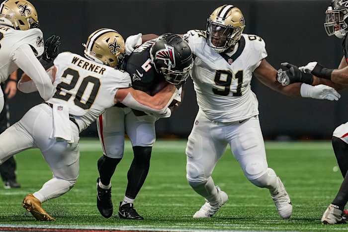 Sep 11, 2022; Atlanta, Georgia, USA; Atlanta Falcons running back Damien Williams (6) is tackled by New Orleans Saints linebacker Pete Werner (20) and defensive tackle Kentavius Street (91) during the first quarter at Mercedes-Benz Stadium.